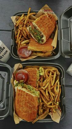 two trays filled with sandwiches and french fries
