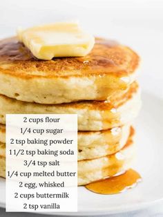 stack of pancakes with butter on top and two cups of syrup in the middle for toppings