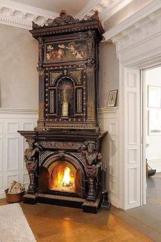 an ornate fireplace in the middle of a room with wood flooring and white walls