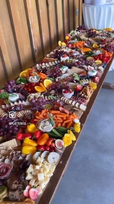 a long table filled with lots of different types of food on top of each other