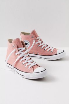 a pair of pink sneakers with white laces
