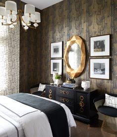 a bedroom decorated in black and white with gold accents