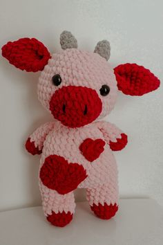 a crocheted stuffed animal with red and white spots on it's body