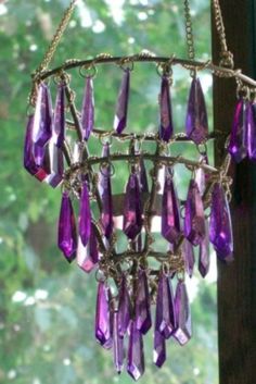 a purple chandelier hanging from the side of a window
