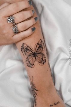 a woman's arm with a butterfly tattoo on it