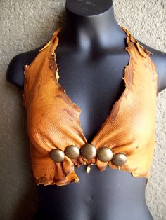 a mannequin wearing a brown top with buttons