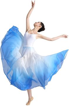 a woman in a blue and white dress is doing a ballet move with her arms outstretched