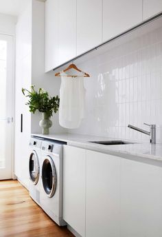 a washer and dryer in a white kitchen