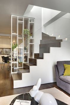 a living room filled with furniture and a stair case