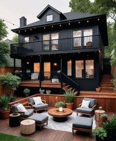 a black house with wooden decking and outdoor furniture