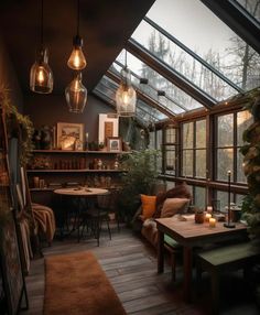 a room filled with lots of windows and furniture next to a wooden floor covered in plants