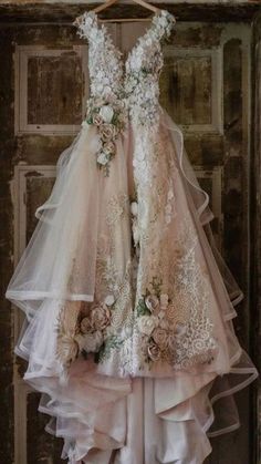 a dress hanging on a door with flowers and ribbons around the neck, as if it were made out of tulle