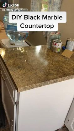 a kitchen counter top with the words diy black marble countertop on it's side