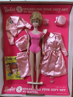 a barbie doll in a pink bathing suit and matching hair with other items from the 1960s's