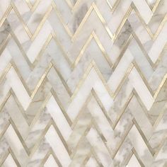 a white marble wall with gold chevrons