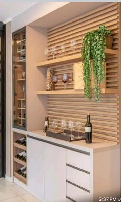 a kitchen with wine bottles and glasses on the counter