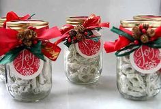 three mason jars filled with candy and bows