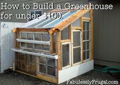 a small greenhouse built into the side of a house