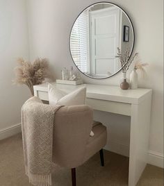 a white desk with a mirror and chair