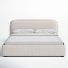 a bed with white sheets and pillows on it's headboard, sitting in front of a wall