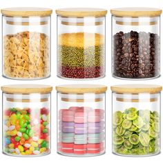 four glass jars filled with different types of candy and candies on white background photo