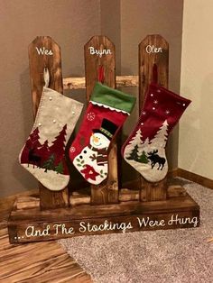 an image of christmas stockings on display in a wooden frame with the words and sayings below them