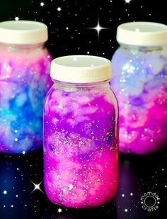 three jars filled with colorful liquid sitting on top of a black table next to the words how to create a nebu jar galaxy