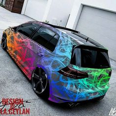 a colorful car parked in front of a garage