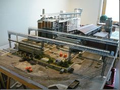 a model train station with buildings and tracks