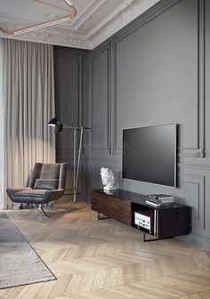 a living room with a large flat screen tv sitting on top of a hard wood floor