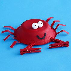 a red crab made out of construction paper with googly eyes on it's head