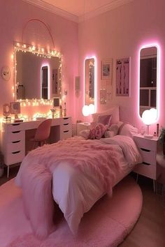 a bedroom decorated in pink and white with lights on the walls, bedding, dressers and mirror