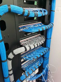 the inside of a server with blue and black wires attached to it's sides