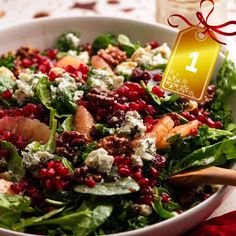 a salad with pomegranate, oranges and feta cheese on it