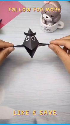 two hands holding an origami piece with the words follow for more like and save