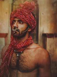 a man wearing a red bandana and nose ring