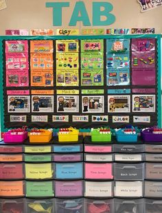 a classroom desk with lots of colorful bins on it