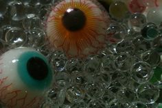 an eyeball is shown in the middle of some glass beads that have been placed on top of each other