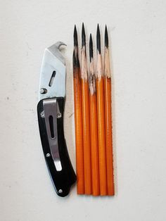 an assortment of pencils and a pair of scissors