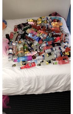 a bed covered in lots of toys and condiments on it's side