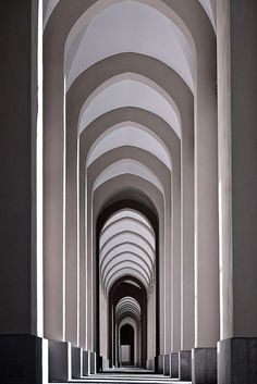 an image of a long hallway with arches