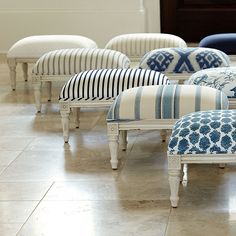 several upholstered chairs and footstools in a room