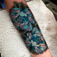 a woman's arm with blue flowers on it