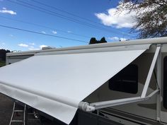 a white awning on the side of a trailer