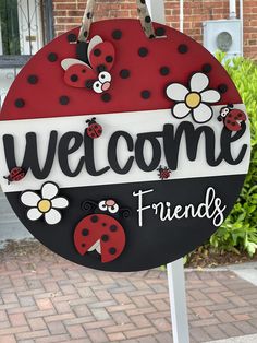 a sign that says welcome friends with ladybugs on it