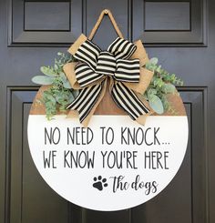 a door hanger that says, no need to knock we know you're here the dogs