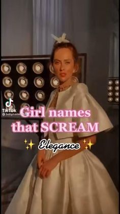 a woman in a white dress standing next to a wall with the words girl names that scream