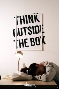 a woman is sleeping on her desk with the words think outside the box above her