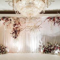 an elegant wedding setup with flowers and chandelier