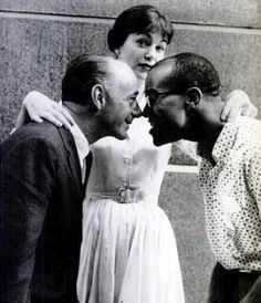 an old photo of three people kissing each other